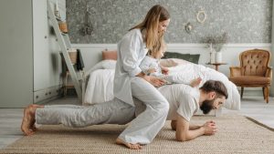 A joyful family enjoys playful bonding in a cozy bedroom, enhancing love and togetherness.